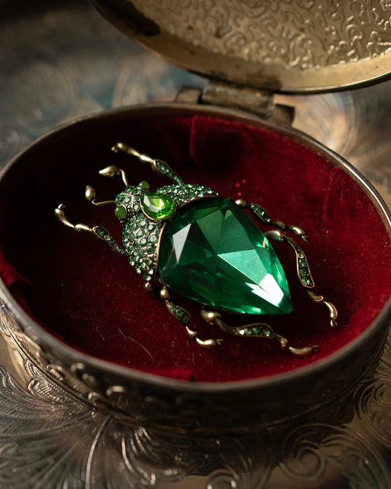 Emerald green bug brooch by Bill Skinner