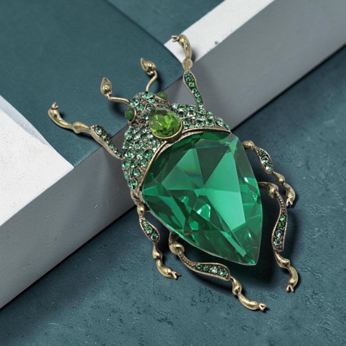 Emerald green bug brooch by Bill Skinner