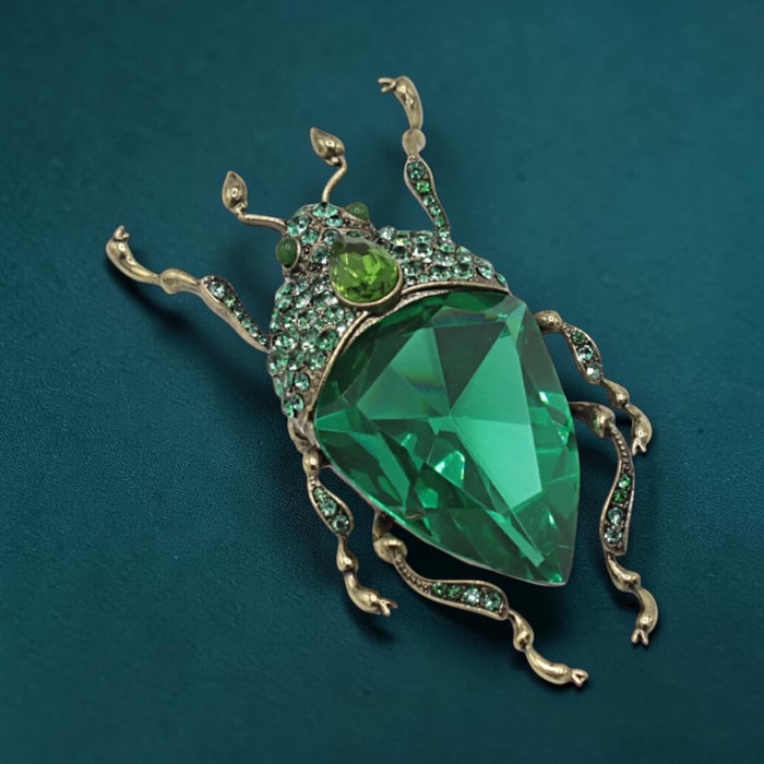 Emerald green bug brooch by Bill Skinner