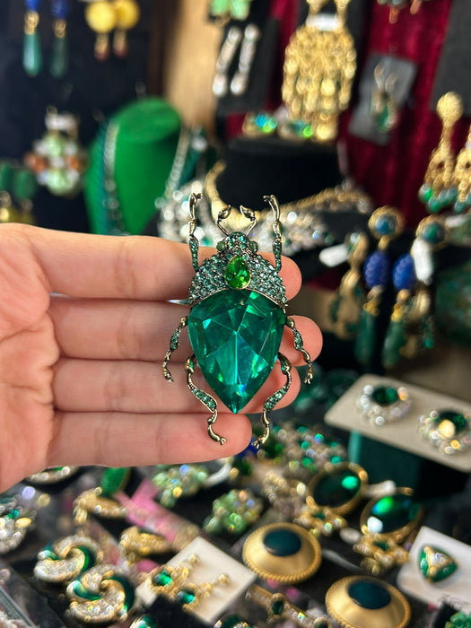 Emerald green bug brooch by Bill Skinner